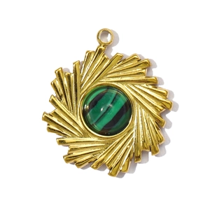 Detailed view of a gold sunburst pendant with a round green malachite stone center