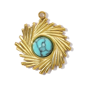 Detail of sunburst gold pendant with inlaid round turquoise stone and natural textures