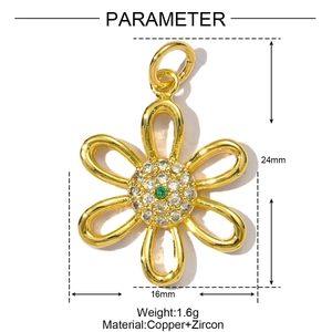 Detail of gold floral pendant with clear cubic zirconia and green center stone