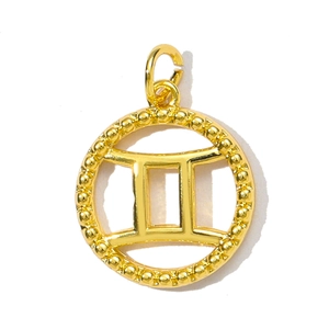 Macro detail of a gold Gemini zodiac pendant featuring beaded edges and open jump ring