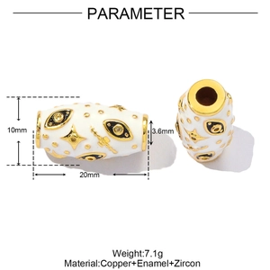 Close-up of white enamel Evil Eye tube bead with gold brass details and zircon accents