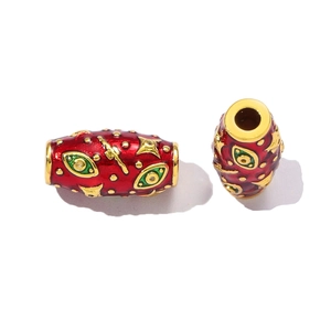 Macro detail of red enamel Evil Eye beads with gold plating and horizontal hole