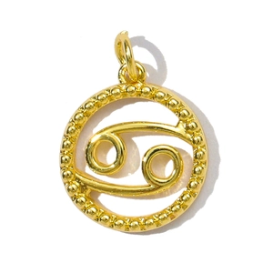 Macro view of a gold-plated Cancer zodiac pendant with beaded edge and polished finish