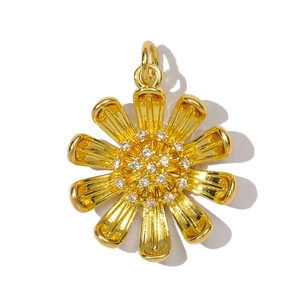 Macro shot of a golden sun flower pendant with sparkling cubic zirconia inlay center