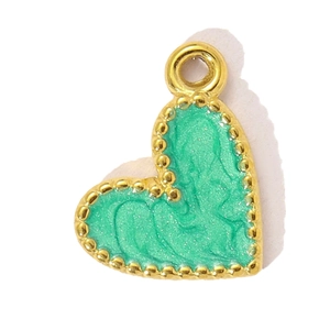 Macro shot of heart-shaped gold-framed pendant with green marble texture and fine glitter