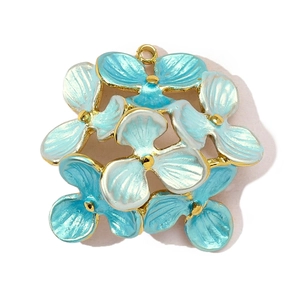 Macro detail of tulip hydrangea flower pendant with blue gradient enamel and gold metal