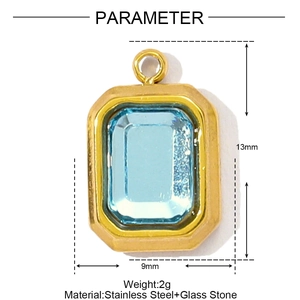 Macro view of gold stainless steel rectangular pendant with a light blue glass gemstone