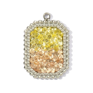 Close-up of a rectangular silver pendant set with yellow and champagne gemstones