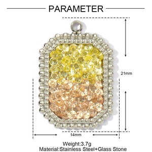 Macro view of rectangular stainless steel pendant with amber glass stones and beaded border