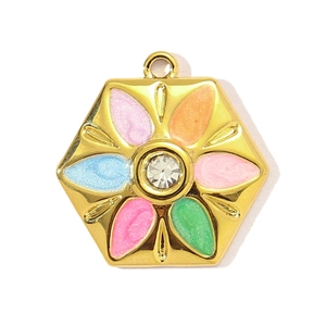 Macro shot of hexagonal stainless steel pendant with colorful enamel flowers and rhinestone