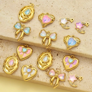 Gold stainless steel charms set with heart, bow, and moon shapes with iridescent stones