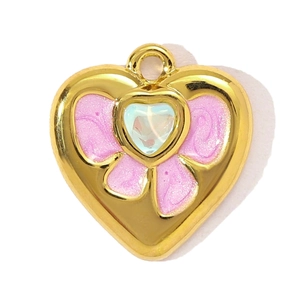 Close-up of heart-shaped gold pendant with pink enamel and iridescent crystal detail