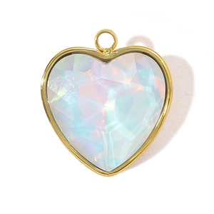 Macro shot of gold-plated stainless steel heart pendant with iridescent faceted glass