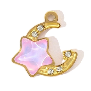 Detailed view of a gold moon pendant featuring a purple star and sparkling rhinestones