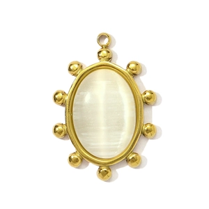 Macro view of gold-plated oval cat eye stone pendant with beaded edge detail
