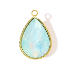 Detail view of pear-shaped light blue faceted glass pendant with golden steel frame