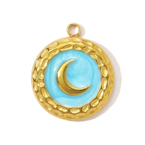Detail of round textured gold crescent moon pendant with light blue enamel finish