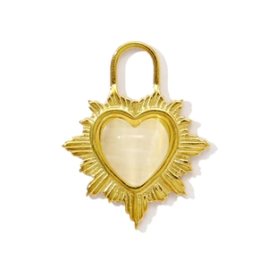 Detail of a heart-shaped cat-eye stone pendant with golden sunburst texture and U-shaped loop