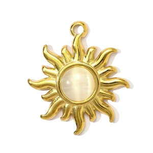 Detailed view of a golden sunburst pendant with a glowing white cat-eye stone inlay
