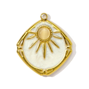 Vintage gold square pendant with cat eye stone and sunbeam design on white background