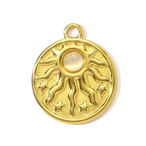 Close-up of golden sun and star relief pendant with a central white cat eye stone