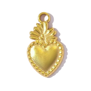 Detail of a golden heart pendant with sunburst top and beaded edge for DIY necklaces
