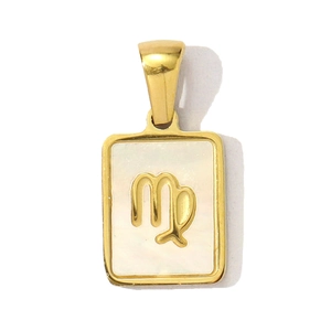 Macro shot of Virgo zodiac pendant with gold frame and shimmering mother of pearl shell
