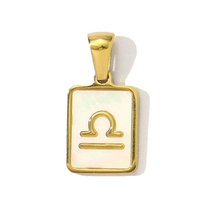 Detail of Libra zodiac pendant featuring gold-plated stainless steel and white shell inlay
