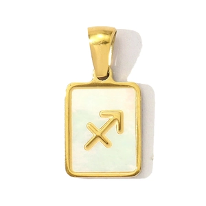 Detailed macro of gold square Sagittarius pendant with white mother of pearl inlay