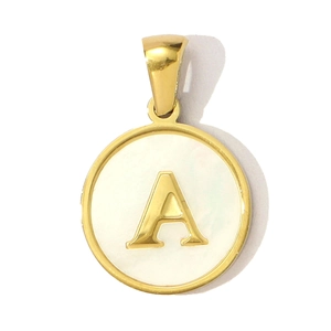 Macro detail of golden letter A necklace pendant with white shell inlay and metal rim