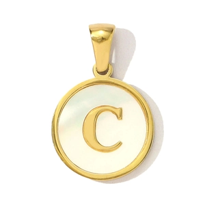 Close-up of golden alphabet C round shell pendant in polished stainless steel