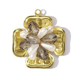 Detail of vintage gold flower pendant with grey crystal beads and white faux pearls