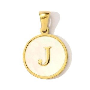 Detail of golden shell pendant necklace featuring a polished letter J on white mother-of-pearl
