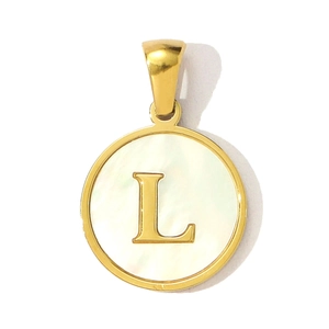 Detailed view of circular gold pendant featuring letter L on mother of pearl inlay