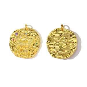 Detailed view of gold Aries zodiac pendant with colorful zircon stones and wavy texture