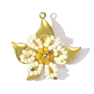 Detailed view of handmade beaded flower pendant in gold and white for jewelry DIY