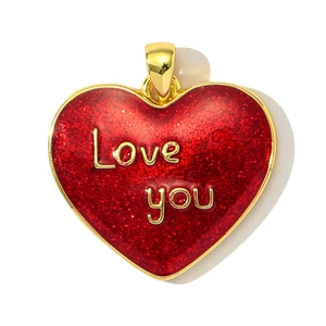 Macro view of a gold heart pendant featuring a red glitter surface and Love You engraving