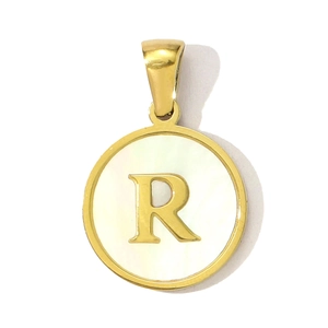Detail of golden shell pendant with letter R, featuring high polished stainless steel finish