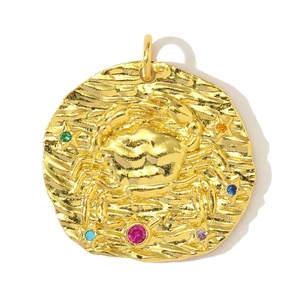 Macro detail of golden Cancer zodiac pendant with colorful zircon stones and wavy texture
