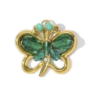 Golden butterfly necklace pendant with emerald green beads and sparkling rhinestone