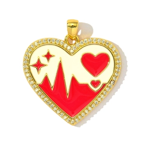 Detail of gold heart pendant with red enamel, starry pattern and sparkling zircon stones
