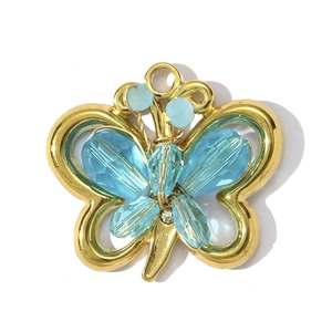 Close-up of golden butterfly pendant with blue crystal beads and zircon details