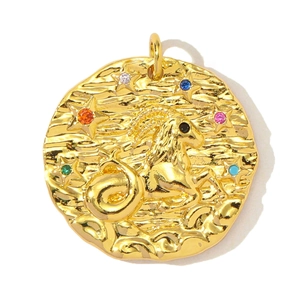 Macro detail of a gold Capricorn zodiac pendant with colorful zircon star inlays