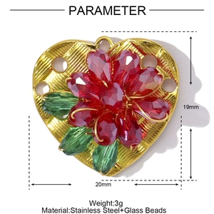 Detail of a heart flower pendant made of stainless steel with red and green glass beads