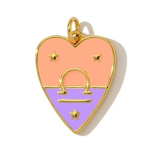 Detail of a heart-shaped Libra zodiac pendant with orange and purple enamel and gold trim