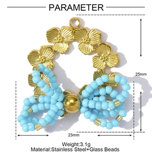 Detail view of flower bow pendant showing 25mm size and blue glass beads on stainless steel