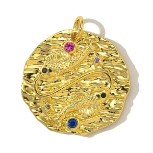Macro detail of gold-plated Pisces zodiac pendant with colorful zircon stones and wave texture