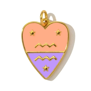 Close-up of heart-shaped copper pendant with pink and purple enamel and gold stars