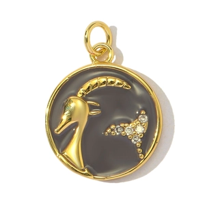Detailed macro view of gold Capricorn zodiac pendant with dark grey enamel and tiny zircons