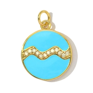 Detail of round gold-plated zodiac pendant with blue enamel and sparkling zircon wave